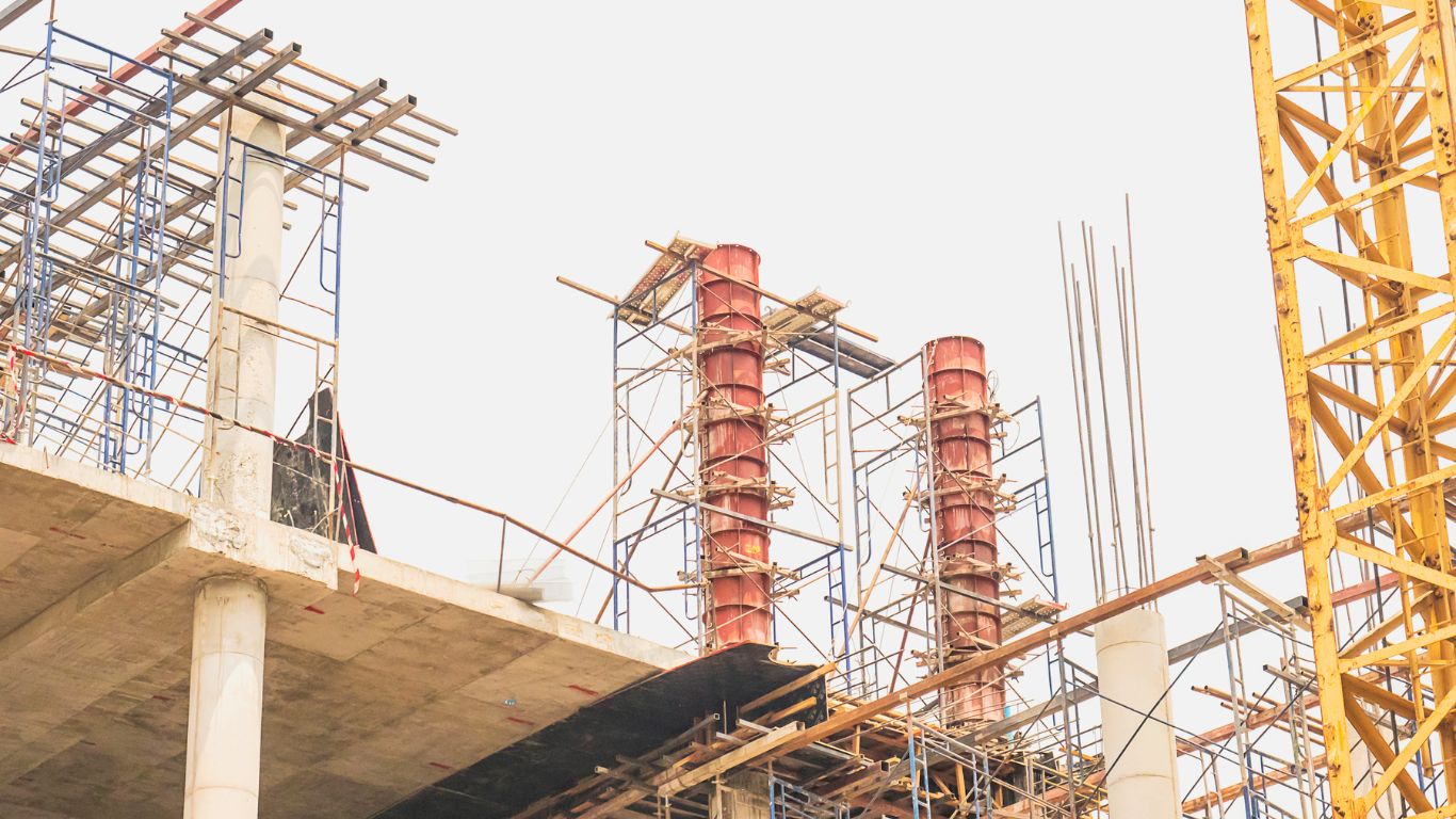 Post tension repair in progress with scaffolding on a construction site.